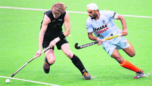 Tarrant Blair of New Zealand (L) and Gurwinder Singh Chandi compete for the ball during the Sultan Azlan Shah Cup hockey tournament in Ipoh