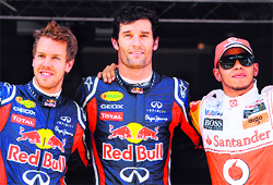 Sebastian Vettel (L), Mark Webber (C) and Lewis Hamilton celebrate on the podium after the qualifying session in Barcelona on Saturday