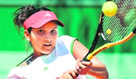 Sania Mirza hits a return to Kristina Barrois at the French Open in Paris on Monday.