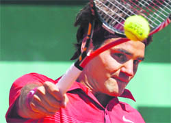 Roger Federer in action against Maxime Teixeira in the men's second round of the French Open championship at the Roland Garros Stadium in Paris on Wednesday.