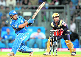 Sachin Tendulkar (L) watched by Shreevats Goswami, plays a shot during the IPL Twenty20 match between Mumbai Indians and Kolkata Knight Riders at the Wankhede Stadium in Mumbai on Wednesday. 
