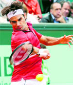 Roger Federer thunders a return against Janko Tipsarevic in the French Open Championship at the Roland Garros Stadium in Paris on Friday