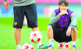 Barcelona's forward Lionel Messi sits on a ball during a training session on the eve of the UEFA Champions League final match vs Man-U on Friday.