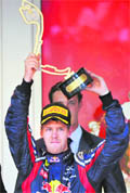 Sebastian Vettel celebrates after winning at the Circuit de Monaco in Monte Carlo on Sunday