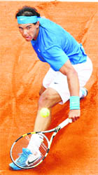 Rafael Nadal returns the ball to Ivan Ljubicic during their match at the Roland Garros stadium in Paris on Monday. 