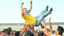 Players of Sagaocar Sports Club toss up their coach, Karim Bencherifa to celebrate winning the I-League after their victory over JCT FC in Ludhiana on Monday.