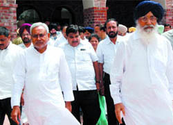 Bihar Chief Minister Nitish Kumar and BJP president Nitin Gadkari coming out of the Badals� mansion after paying their condolences over the demise of Punjab Chief Minister Parkash Singh Badal�s wife Surinder Kaur Badal, at Badal village