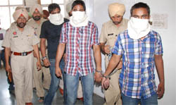 The accused in petrol pump robbery case being presented before mediapersons in Bathinda on Saturday. 