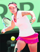 Li Na hits a return against Francesca Schiavone during their women's final at the Roland Garros stadium in Paris on Saturday. 