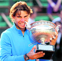 Rafael Nadal bites the cup after defeating Roger Federer in the men's final at the Roland Garros stadium in Paris on Sunday.