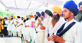 Devotees offer ardas at Akal Takht on the anniversary of Operation Bluestar in Amritsar on Monday.