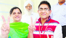 Class XII topper Rohit flashes a victory sign after the results were declared, in Patiala. 