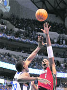 Chris Bosh #1 of the Miami Heat attempts a shot against Ian Mahinmi of the Dallas Mavericks in Game Three of the NBA Finals at American Airlines Center in Dallas on Sunday. �