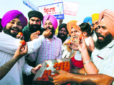 Activists of Sikh Students Federation (Mehta) celebrate the lifting of the ban on carrying kirpan by baptised Sikh employees in the apron area of the Sri Guru Ramdas International Airport in Amritsar on Tuesday