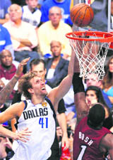 Dallas Mavericks Dirk Nowitzki (L) gets past Miami Heat Chris Bosh during Game 4 of the NBA Finals in Dallas, Texas 