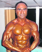 Meharban Singh Virk flexing his muscles at a Bodybuilding meet.