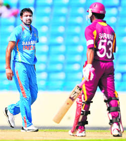 Praveen Kumar (L) reacts after dismissing Ramnaresh Sarwan in the fourth ODI at the Sir Vivian Richards Stadium in St John's, Antigua 