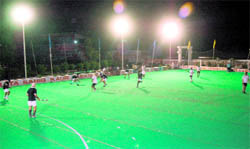 Players in action under floodlights at the Jarkhar Stadium near Ludhiana