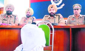 Officials with the contraband at the Police Lines in Patiala on Thursday.