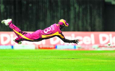 West Indies cricketer Anthony Martin dives to field a ball during the fifth ODI against India in Kingston on Thursday