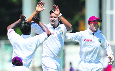 West Indies bowler Ravi Rampaul (C) celebrates after taking the wicket of Murali Vijay in Kingston, Jamaica, on Monday
