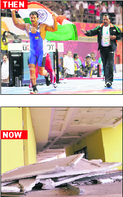 Indian wrestler Narsingh Yadav celebrates victory in the 74kg freestyle category and (below) sad state of the venue