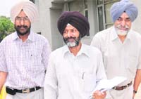 Suspended employees Jagtar Singh, Roshan Lal Sood and Avtar Singh