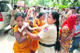 Policewomen try to stop activists of the AIE Teachers Front from going to district administrative complex, Bathinda, on Friday.