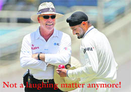 Daryl Harper (L) shares a light moment with Harbhajan Singh 