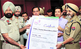 Punjab Director General of Police PS Gill presents an ISO 9001 certificate to an SHO in Jalandhar on Saturday.