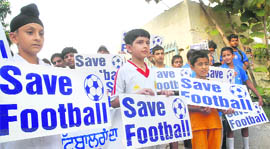 Young football fans appeal to save the JCT team at a march in Jalandhar on Saturday.