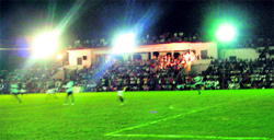 Crowds throng the stadium at night for the final match of the tournament