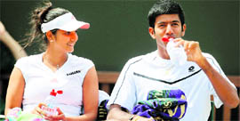 Sania Mirza (L) and Rohan Bopanna sit in the break between games during their match against Martin Damm and Renata Voracova at Wimbledon on Thursday. 