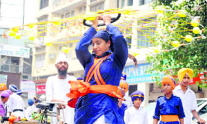 A visually impaired girl performs gatka during a nagar kirtan to mark the birth anniversary of Guru Hargobind, in Patiala on Tuesday