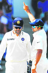 MS Dhoni (L) and Raina discuss tactics between overs in the West Indies.