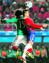 Chile's Alexis Sanchez (R) and Mexico's Hector Reynoso in action in Argentina on Monday. 