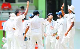 Indian players celebrate the wicket of Kieran Powell in Roseau, Dominica on Wednesday.