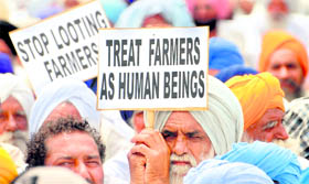 Members of the BKU (Rajewal) protest against the recent fuel price hike, near Phase VIII, Mohali, on Friday. They later submitted a memorandum to the Punjab Governor.