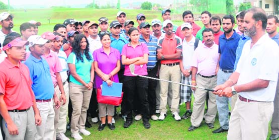 Coach Jesse Grewal (R) explains the finer points of the game to aspiring golf coaches at the CGA Range in Chandigarh 