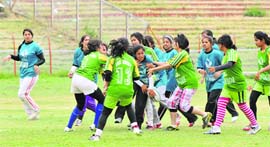 Girls in action during an exhibition match at Bakshi stadium in Srinagar