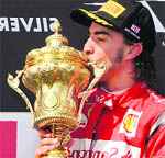 Ferrari's Fernando Alonso celebrates on the podium after winning the British Grand Prix.