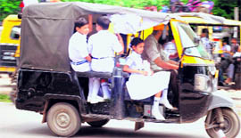 Schoolchildren in an overloaded autorickshaw in Patiala.