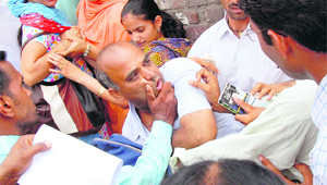 A passerby being manhandled by EGS volunteers in Bathinda. 
