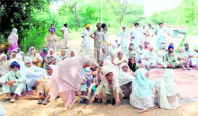 Residents of Jethuke village block the Bathinda-Barnala road for at Jethuke (near Rampura Phul) in protest against the non-fulfilment of promises related to power, in Bathinda on Tuesday.