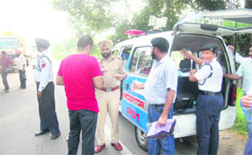 Patiala cops challan a traffic violator after the inauguration of the speed camera van, at the Sangrur road in Patiala on Thursday.