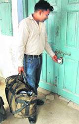 An official checks the seal at the Government Ayurvedic Pharmacy in Patiala 
