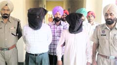 The accused (L in veil) in police custody