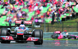 McLaren Mercedes' Jenson Button (L) drives at the Hungaroring circuit and celebrates on the podium (R) in Budapest on Sunday