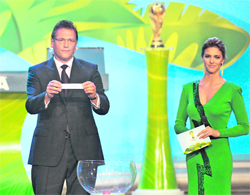 FIFA�s Secretary General Jerome Valcke (L) draws South America next to Brazilian actress and model Fernanda Lima during the Preliminary Draw for the 2014 FIFA World Cup in Rio de Janeiro on Saturday