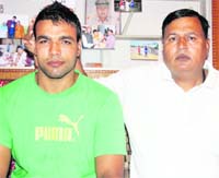 Arun Hooda (L) with his father Bhagwaan Hooda, before leaving for the Asian Boxing Championship in South Korea